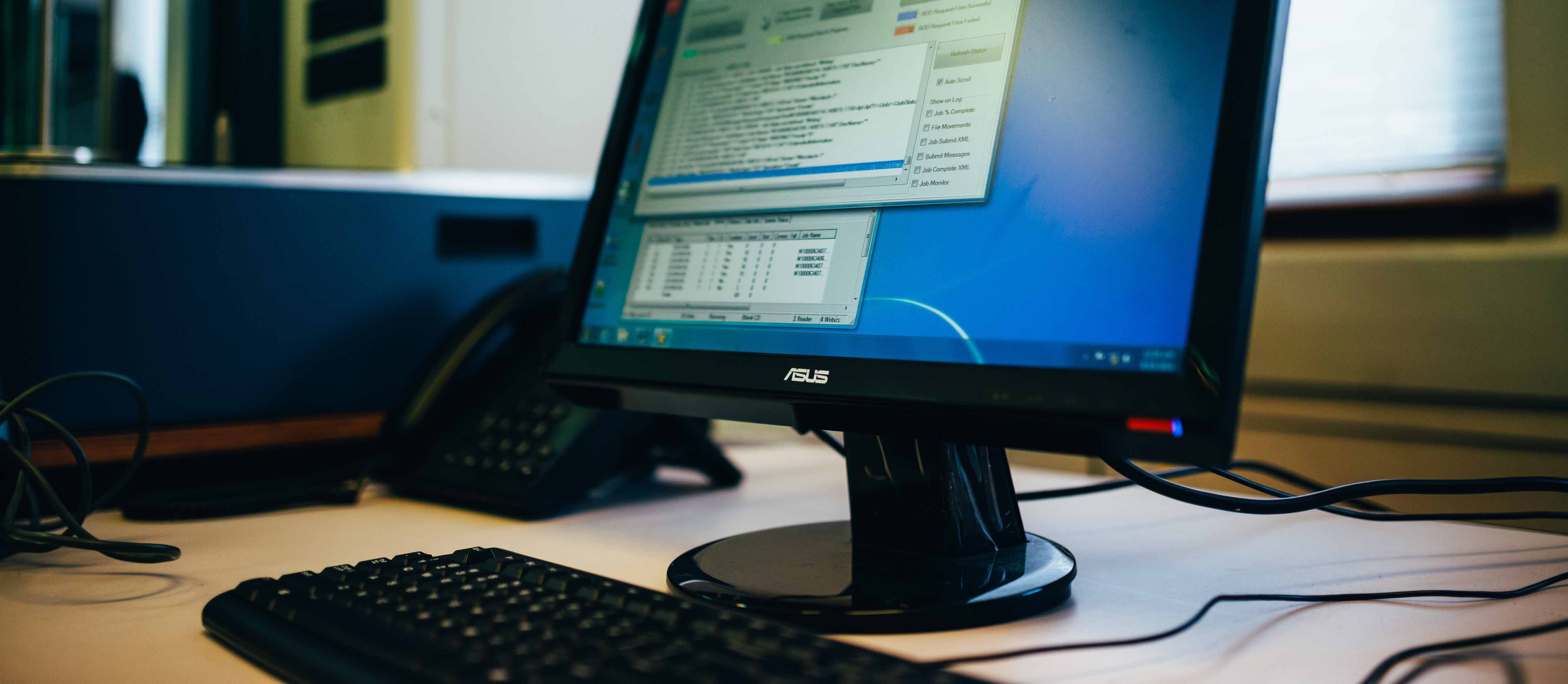 Computer on a desk in an office.