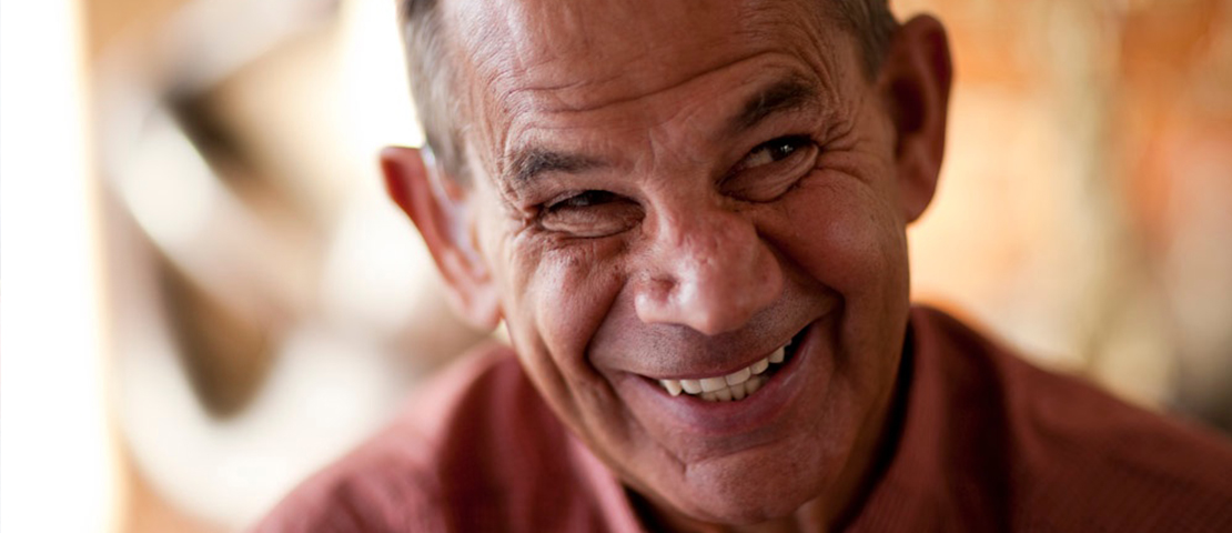 A man smiling and looking to the side