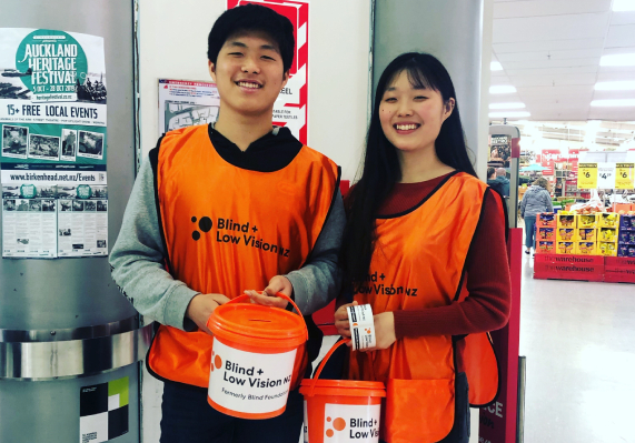 two volunteers help us to collect the donation