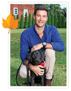 Neve sit on grass with Clarke Gayford